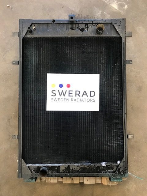 En stor, rektangulär kylare märkt "Kylare Volvo Penta" med märkena "SWERAD" och "SWEDEN RADIATORS" i mitten, liggande platt på en träpall på ett betonggolv.